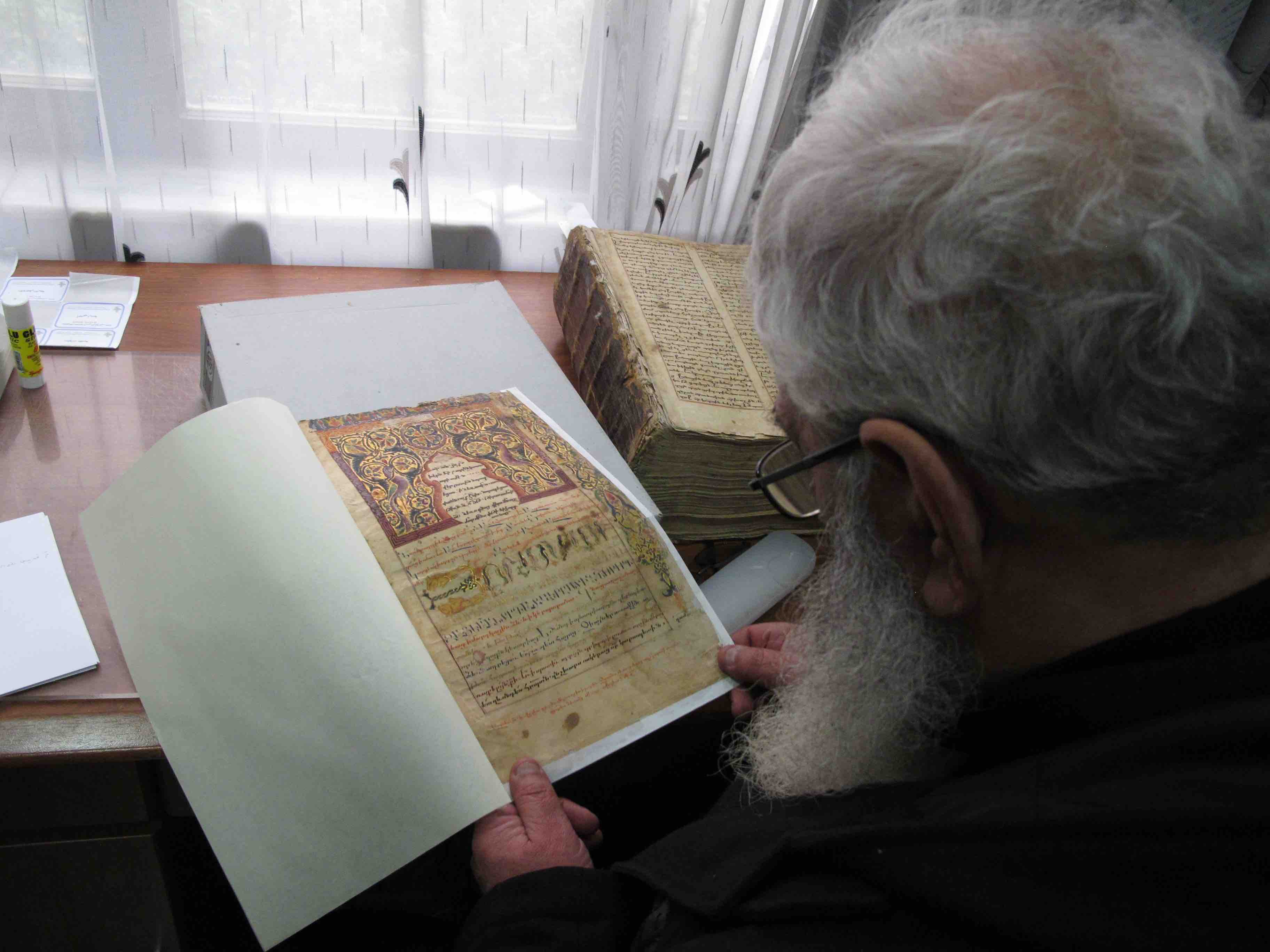 Examining an Armenian manuscript at CNMO